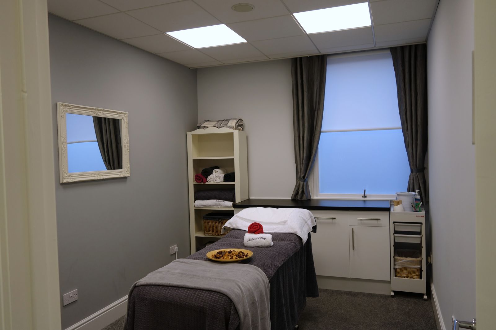 A treatment room at Nature’s Way, the couch made up with towels and daylight coming in from the window.